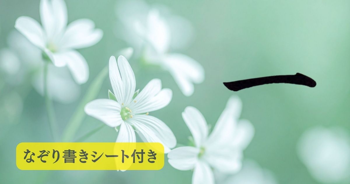 筆文字「一」。背景には緑の自然の中に、白い可憐な花が咲いている。